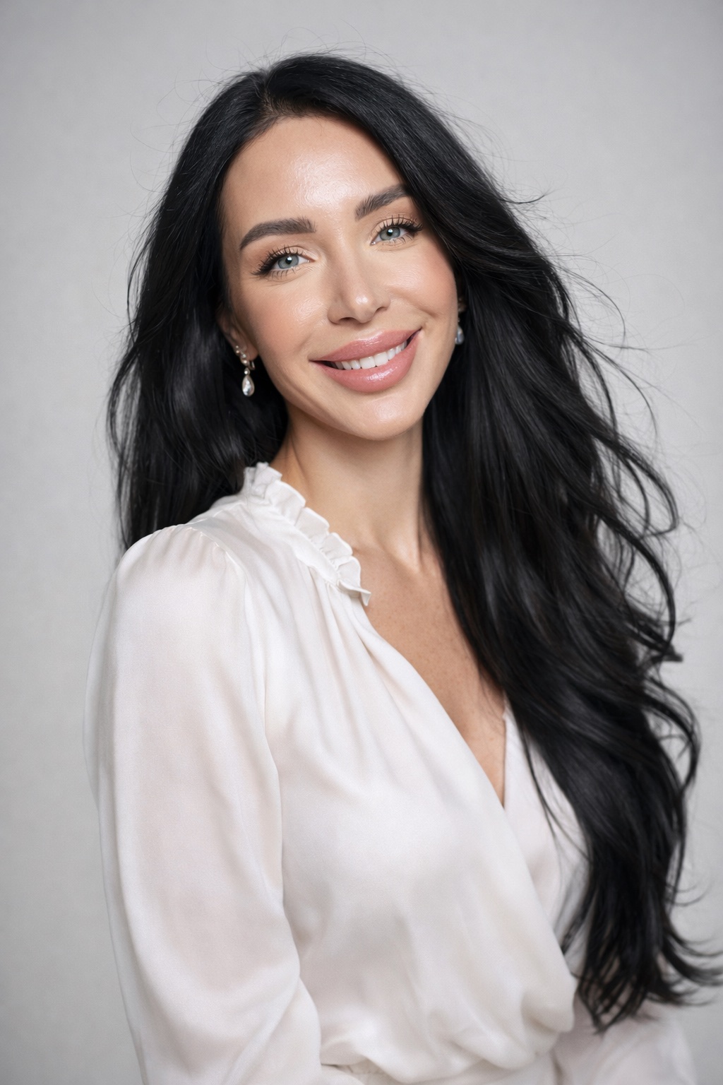 Studio portrait in a white silk blouse